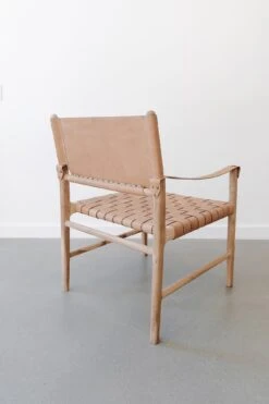 Safari Lounge Chair - Beige -Saffron + Poe Back Leather Strap Safari Lounge Beige against white wall