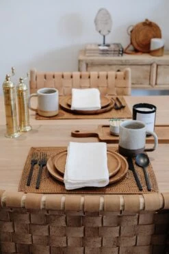 Ivory Linen Napkin -Saffron + Poe Styled front view of Ivory Linen Napkin with Teak Plates and Woven Tenganan Placemat