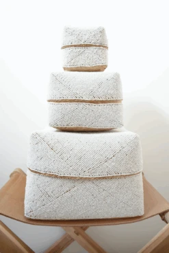 Hand-Beaded Bali Baskets - Solid White -Saffron + Poe hand beaded bali basket three stacked on leather chair
